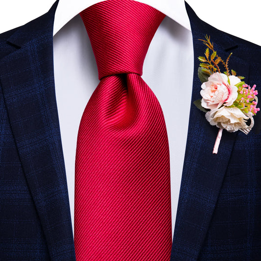 Red textured pattern tie with matching cuff links and pocket square