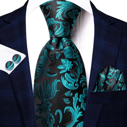 black and turquoise floral pattern tie with matching cuff links and pocket square