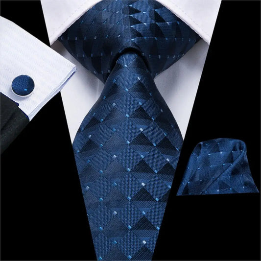 dark blue geometric design tie with matching cuff links and pocket square