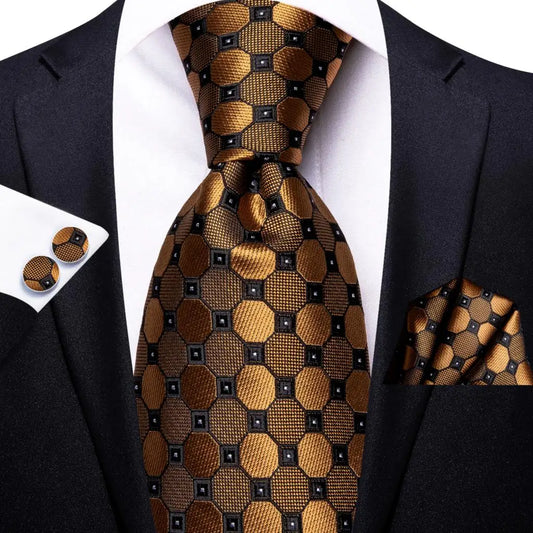 gold and black geometric pattern tie with matching cuff links and pocket square