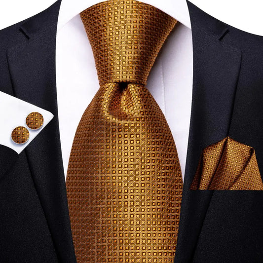 gold geometric pattern tie with matching cuff links and pocket square