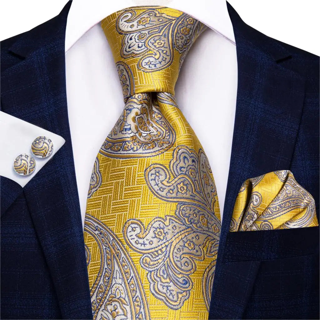 gold paisley tie with cuff links and pocket square