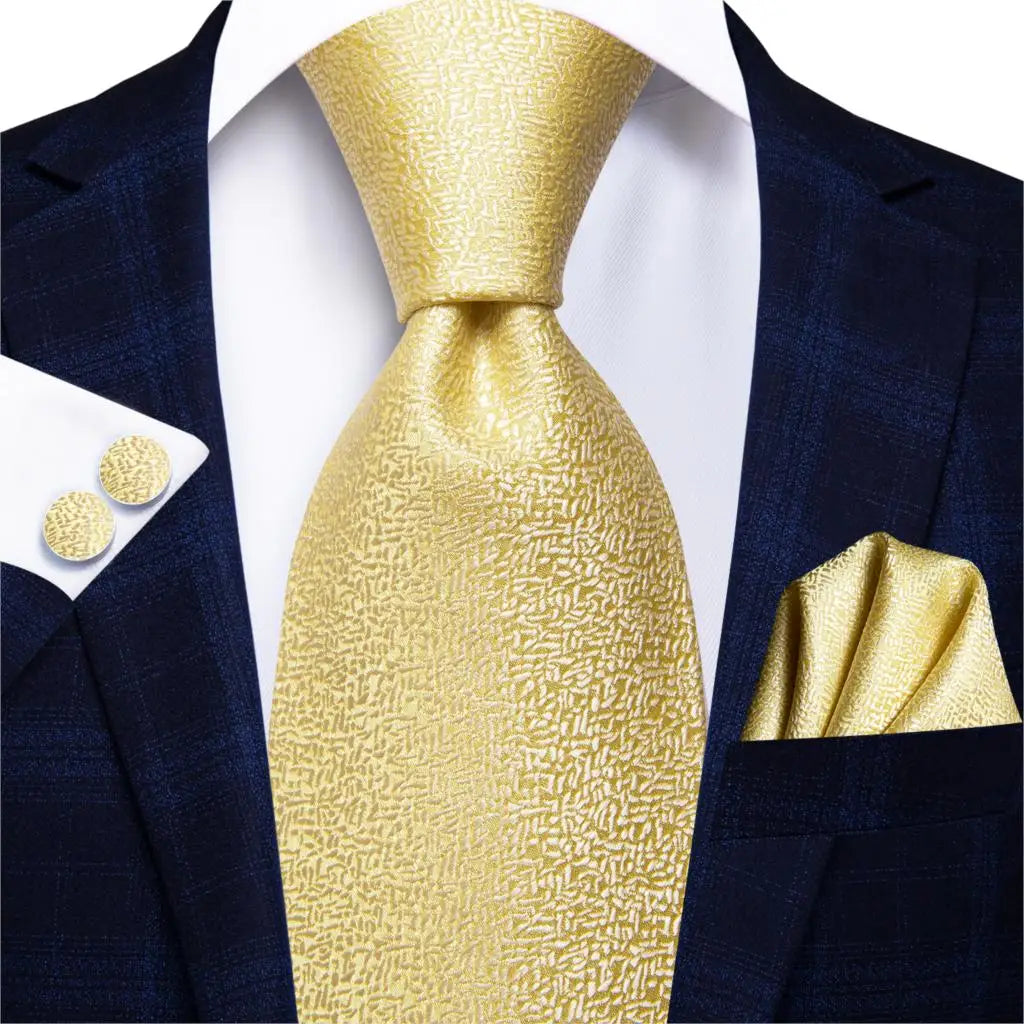 gold textured tie with cuff links and pocket square