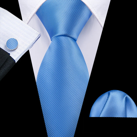 plain blue tie with matching cuff links and pocket square