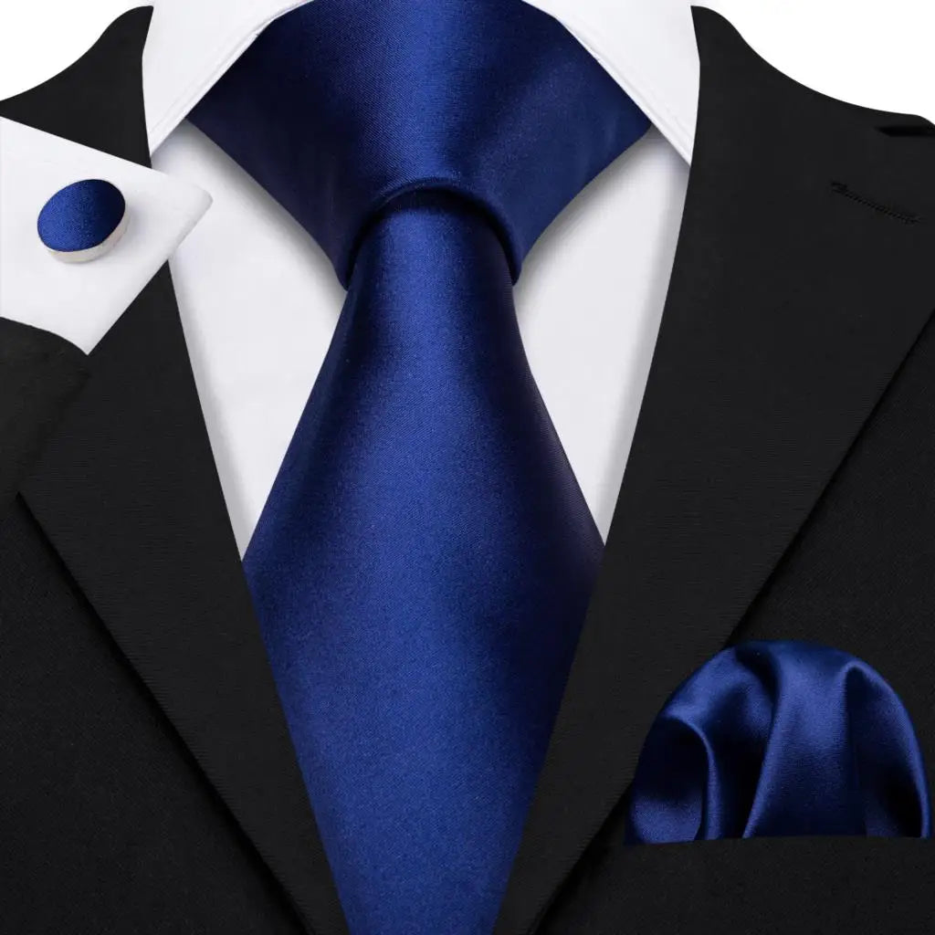 plain dark blue tie with cuff links and pocket square